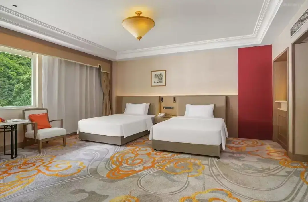 Luxurious hotel room interior with neatly made bed and modern decor